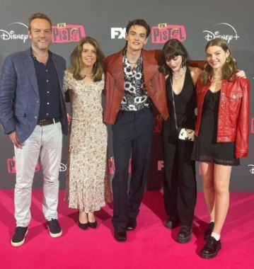 Louis Partridge with his parents and siblings